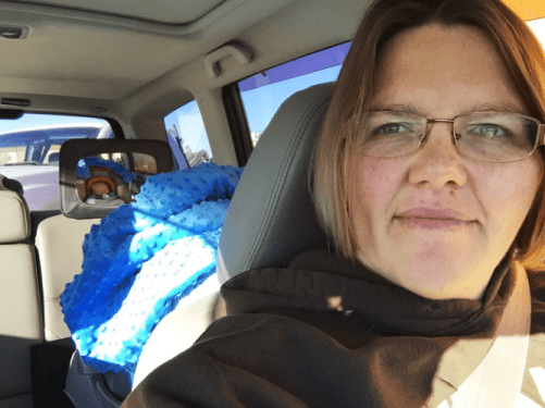 Tricia Olson takes a selfie of herself and her son Augustus, or Gus, who sits in his car seat. Olson took three weeks of unpaid leave from her job at a towing company in Rock Springs, Wyo., after giving birth. Courtesy of Tricia Olson